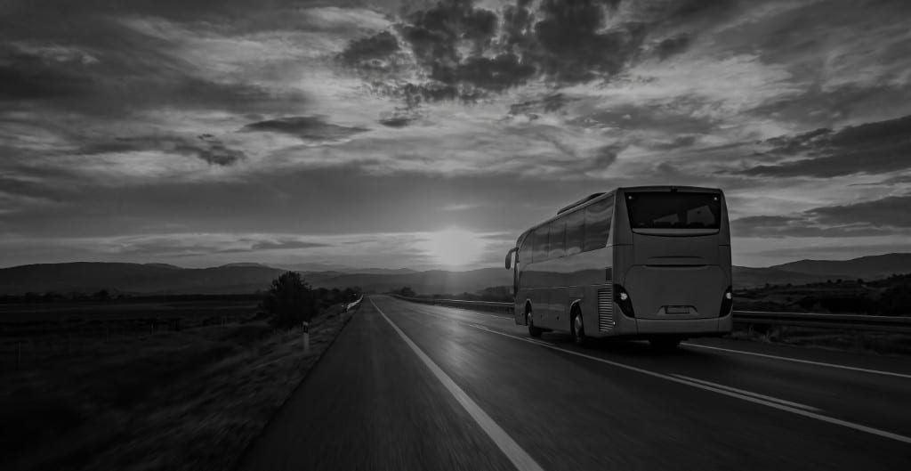 Coach on the road at dusk