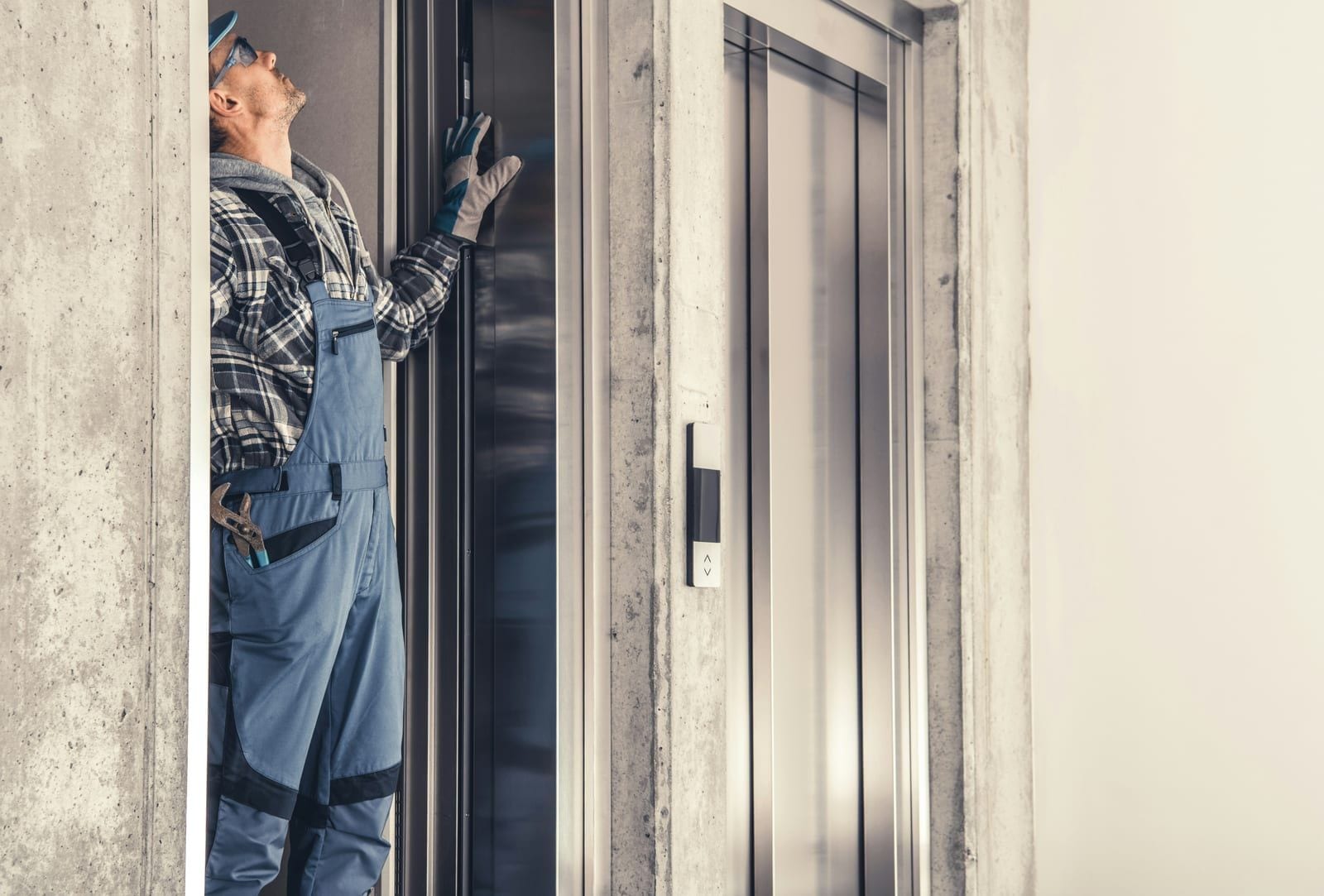 Technician with a phone next to a control cabinet