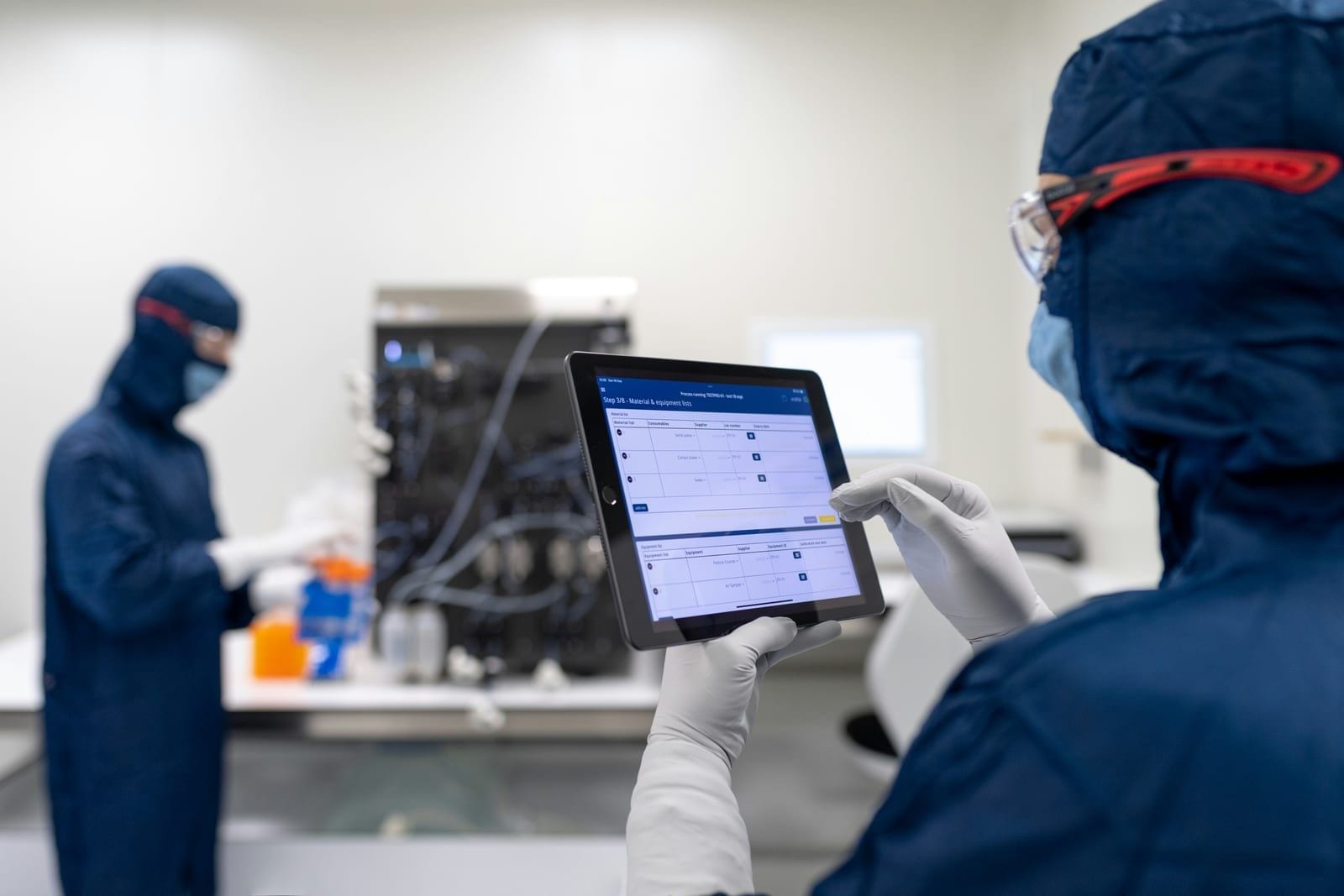 Technician with a tablet in front of a machine